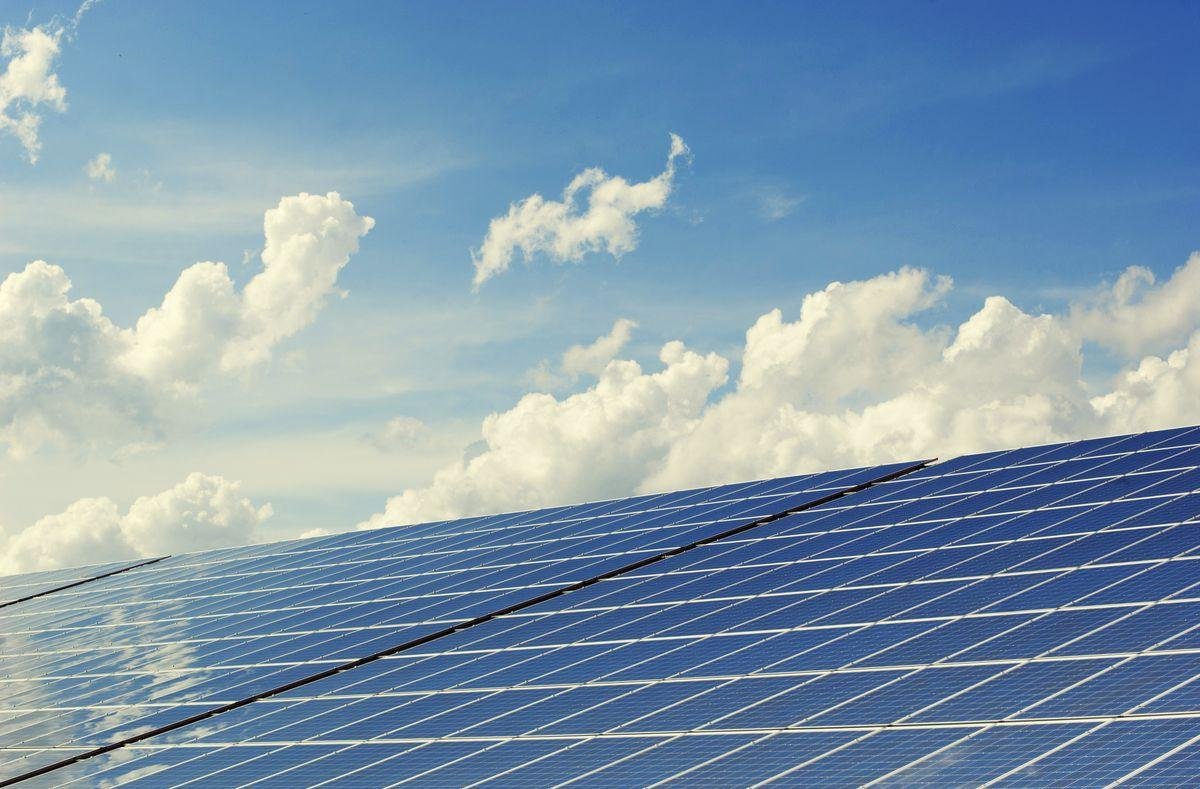 Solar panels under blue sky - rooftop solar installation